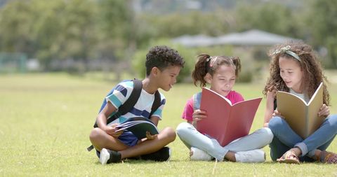 Joyful Children Reading Together Outdoors in Park - Download Free Stock Images Pikwizard.com