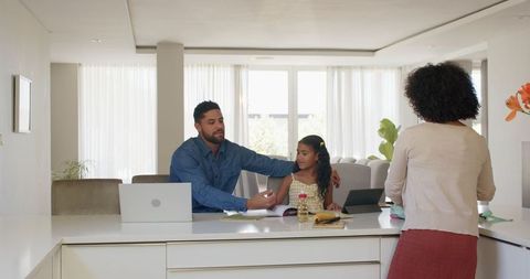 Family homework discussion at kitchen counter