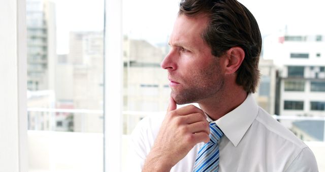 Businessman thinking with city view in background - Download Free Stock Images Pikwizard.com