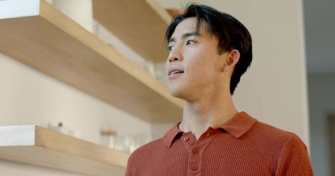 Man in casual shirt looking at modern interior decor