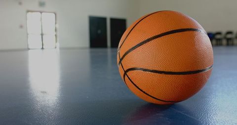 Orange basketball on indoor gym floor