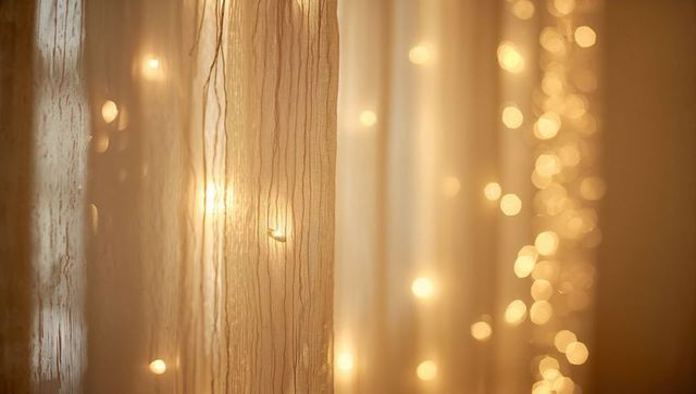 Filtering sheer curtain revealing golden string lights, soft bokeh glow for cozy interiors