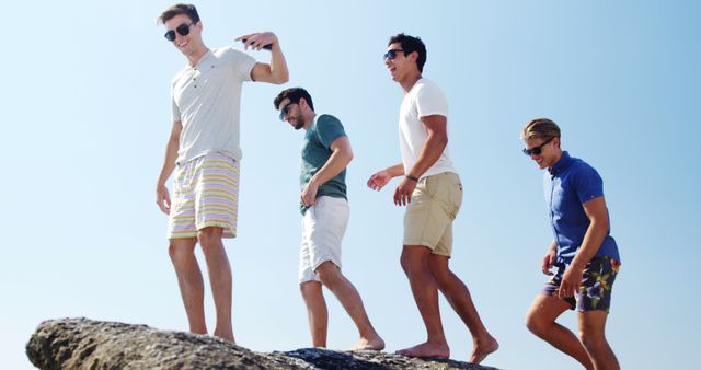 Group of Friends Enjoying Sunny Day on Rocky Cliff Edge - Download Free Stock Images Pikwizard.com