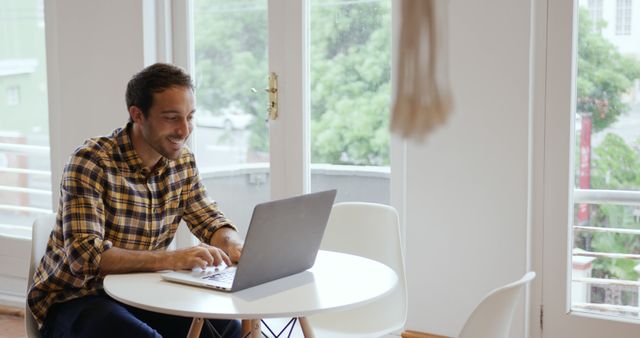 Smiling Man Working Remotely on Laptop at Home - Download Free Stock Images Pikwizard.com