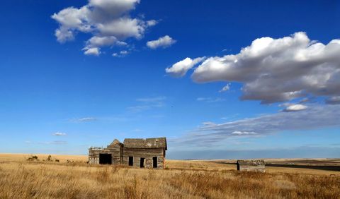 Abandoned House on Vast Countryside Under Blue Sky