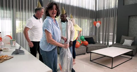 Colleagues cleaning up after office party