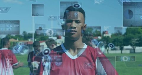Youth soccer player standing on pitch with futuristic hud overlays for sports analytics