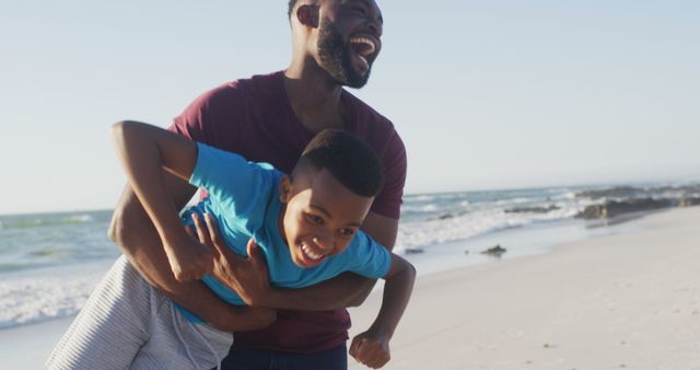 Joyful Father and Son Playing on Beach at Sunset - Download Free Stock Images Pikwizard.com