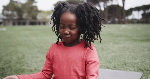 Young Girl Practicing Mindfulness in Park Environment