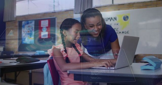 Teacher Helping Child Use Laptop in Educational Environment