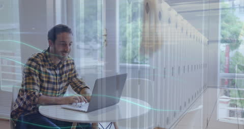 Man Working on Laptop with Digital Data Overlay