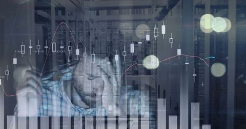 Data analyst working in modern server room with financial graphs