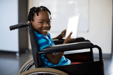 smiling boy in wheelchair using tablet in transparent classroom - Download Free Stock Videos Pikwizard.com