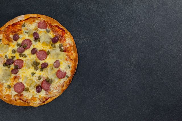 Overhead View of Delicious Italian Pizza on Grey Background - Download Free Stock Photos Pikwizard.com
