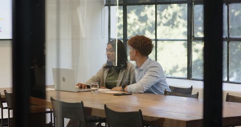 Diverse Colleagues Collaborating in Stylish Office with Modern Technology