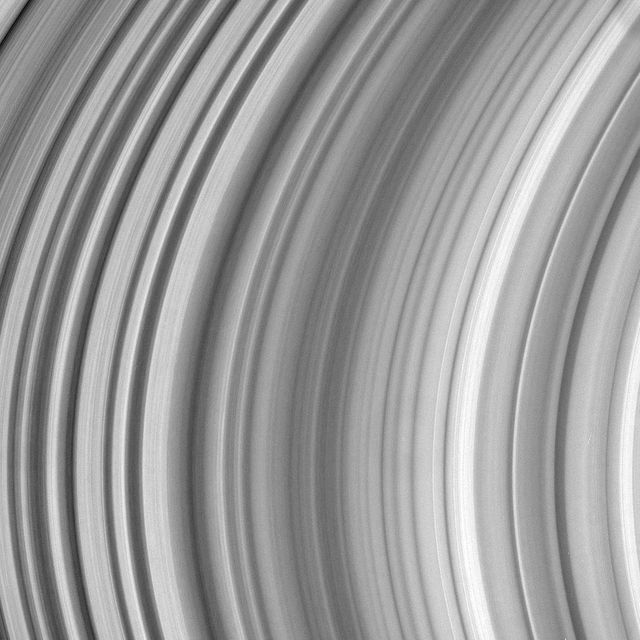 A detailed close-up view of Saturn's B Ring showcasing its intricate patterns and texture. This image is perfect for educational materials on planetary science, presentations on space exploration, or as a visually striking addition to science-related articles and publications.