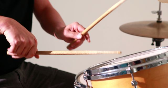 Drummer playing his drum kit on white background