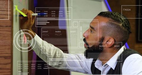 Focused professional writing on whiteboard in innovative office