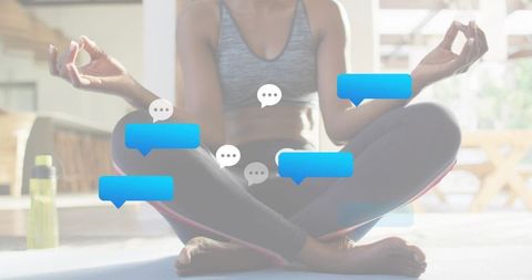 Woman meditating on yoga mat with floating chat bubbles representing digital mindfulness