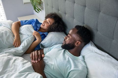 Smiling Couple Relaxing in Comfortable Bedroom Setting