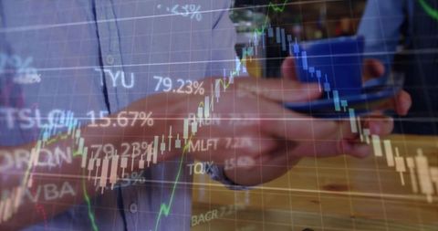 Business professionals analyzing stock market candlestick charts on smartphone at cafe