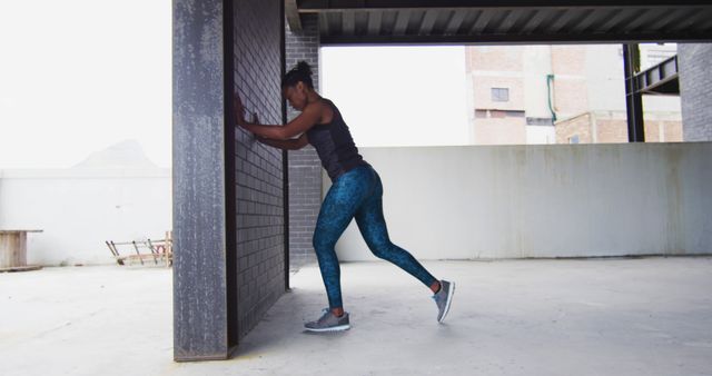 Woman Stretching Leg Muscles Outdoors in Urban Environment - Download Free Stock Images Pikwizard.com