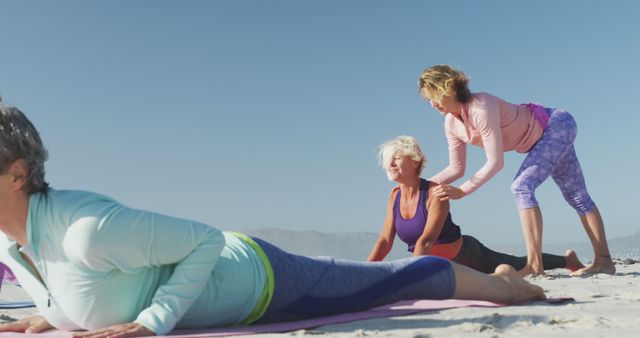 Senior Women Practicing Yoga on Beach with Instructor's Guidance - Download Free Stock Images Pikwizard.com