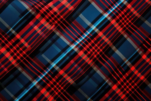 Red and navy tartan plaid pattern perfect for use as seamless background in textile, fashion design, and upholstery. Suitable for creating clothing designs, fabric prints, wallpapers, and digital backgrounds. Provides a stylish and timeless look for various creative projects.