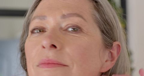 Elegant Silver-haired Woman Radiates Graceful Tranquility at Home