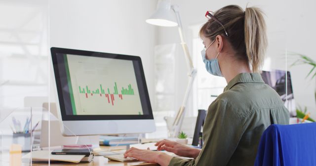 Office Worker Analyzing Data on Computer While Wearing Mask - Download Free Stock Images Pikwizard.com