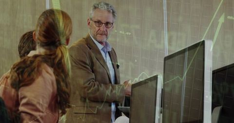 Advisor Analyzing Digital Data with Colleagues in Modern Office