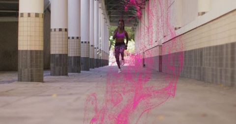 Sprinting Female Runner with Vibrant Pink Effects in Urban Walkway