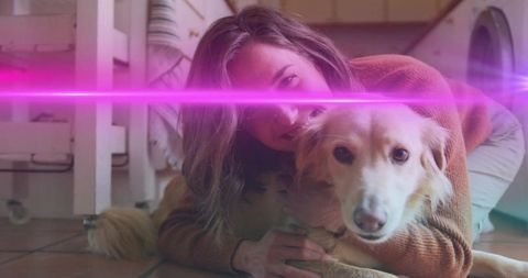 Woman hugging golden retriever on tiled kitchen floor, cuddling, cozy domestic companionship
