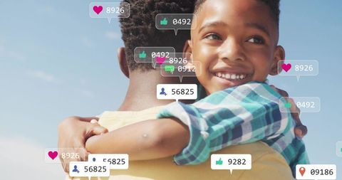 Father carrying son with social media reactions, smiling boy embracing parent under blue sky