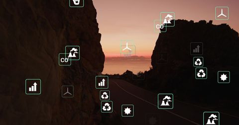 Sustainability Icons Over Scenic Landscape at Sunset