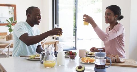 Young Couple Enjoying Healthy Breakfast Together in Kitchen