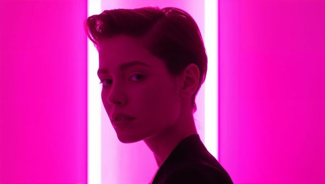 Futuristic portrait of a model against neon pink light panels