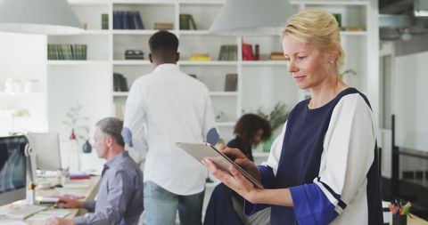 Caucasian Businesswoman Using Tablet in Modern Office Environment