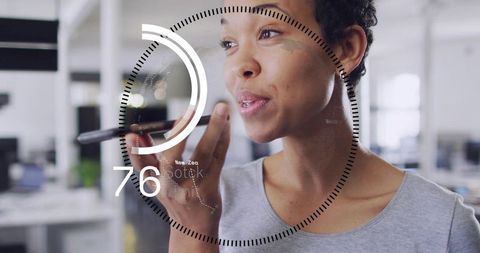 Woman speaking into smartphone with futuristic hud overlay in modern office workspace