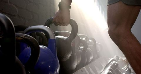 Strengthening with Kettlebell: Determined Workout Session in Gym