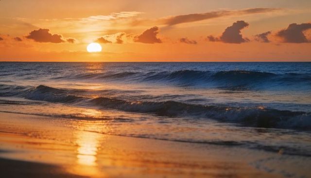 Golden sunset over calm ocean waves reflecting on wet sand at shoreline