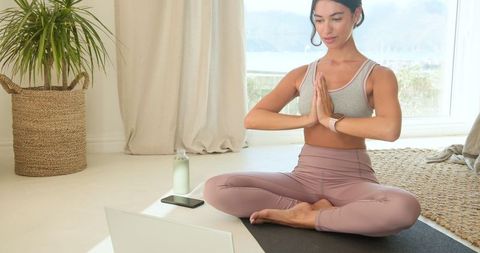 Woman Practicing Yoga Meditation at Home