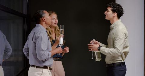 Diverse colleagues networking during office gathering