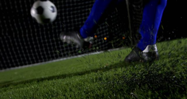 Close-up Soccer Player Kicking Ball Towards Goal Under Stadium Lights - Download Free Stock Images Pikwizard.com