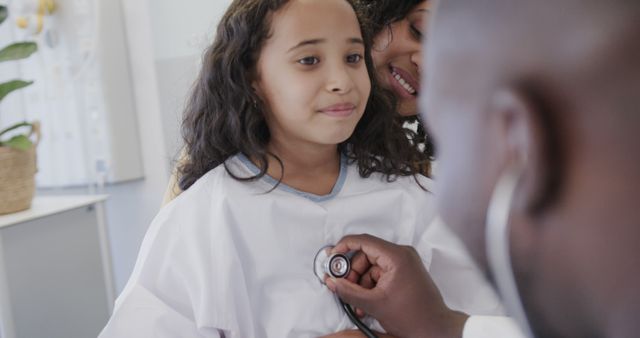 Young Girl at Pediatric Checkup with Doctor and Mother - Download Free Stock Images Pikwizard.com