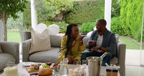 African American Couple Enjoying Relaxed Patio Gathering