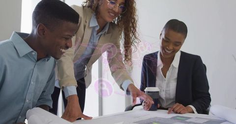 Architect leading team reviewing blueprints in modern office collaboration design planning
