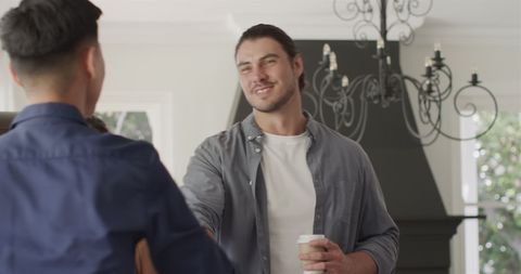 Friends Laughing Together During Festive Home Gathering