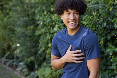 Joyful African American Man Relaxing in Lush Green Garden