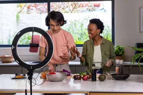 Filming Cooking Collaboration: Asian Man and African American Woman Preparing Salad